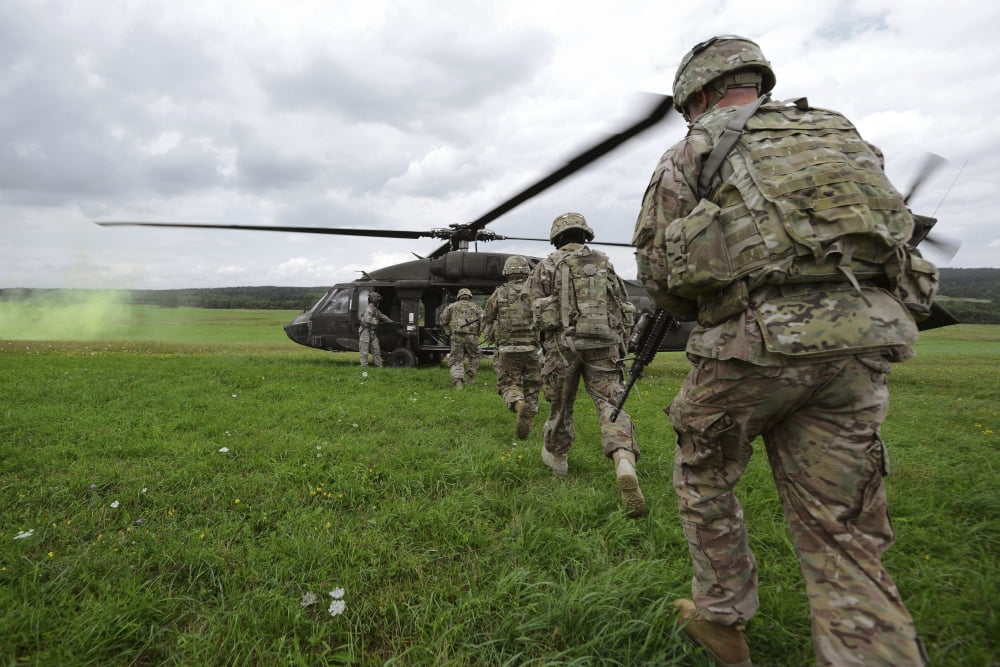 US Army soldiers board a UH-60 Black Hawk helicopter Canvas Art - Stocktrek Images (35 x 23)
