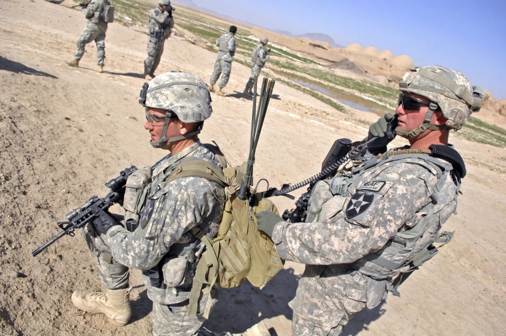 US Army soldiers call in an update during a humanitarian assistance mission in Afghanistan Canvas Art - Stocktrek Images (34 x 23)
