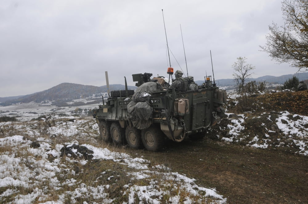 US Army soldiers pull security in a Stryker armored vehicle Canvas Art - Stocktrek Images (35 x 23)