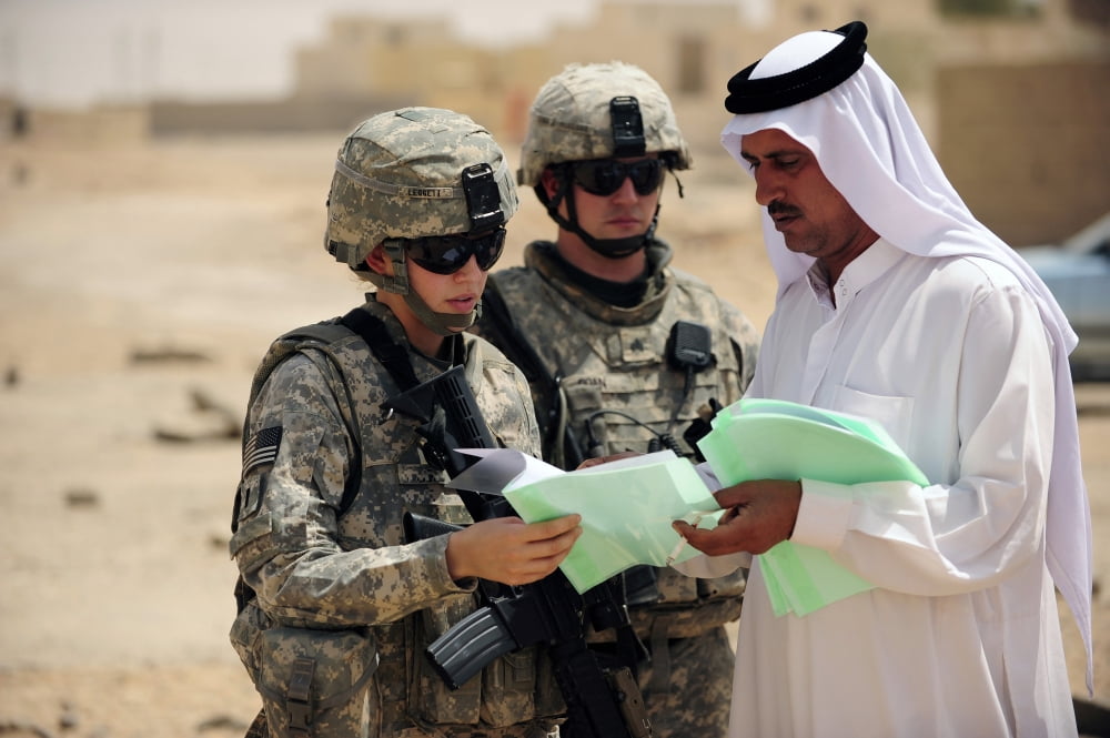 US Army soldiers talking with a town leader about a site survey of businesses in Sequor Iraq Canvas Art - Stocktrek Images (34 x 23)