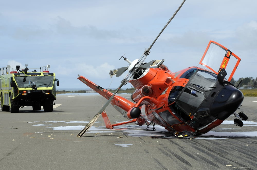 A US Coast Guard MH-65 Dolphin helicopter lays on its side after it crashed at the Arcata Airport during a training mission Canvas Art - Stocktrek Images (34 x 23)