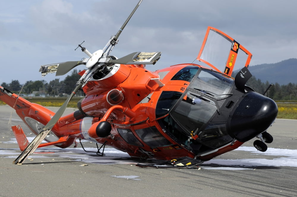 A US Coast Guard MH-65 Dolphin helicopter lays on its side after it crashed at the Arcata Airport during a training mission Canvas Art - Stocktrek Images (34 x 23)