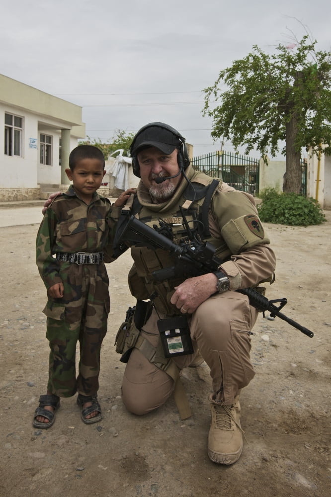 US Contractor poses for a picture with an Afghan child Canvas Art - Terry MooreStocktrek Images (24 x 35)