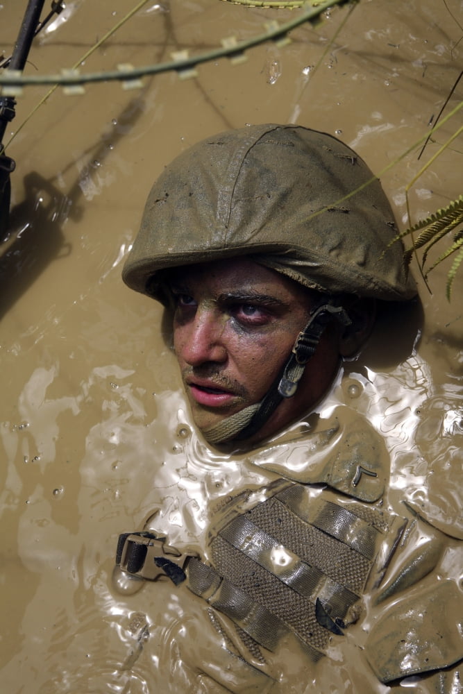 US Marine advancing through an obstacle course at the Jungle Warfare Training Center in Okinawa Japan Canvas Art - Stocktrek Images (23 x 34)
