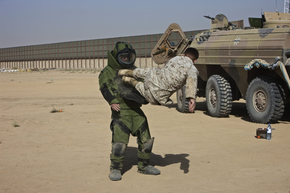 US Marine does a flying kick to a fellow Marine wearing a bomb suit Canvas Art - Terry MooreStocktrek Images (18 x 12)