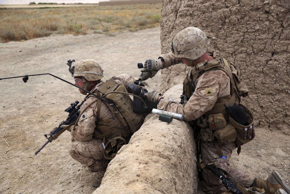 US Marine fills a Camelbak bladder with water for a fellow Marine Canvas Art - Stocktrek Images (34 x 23)
