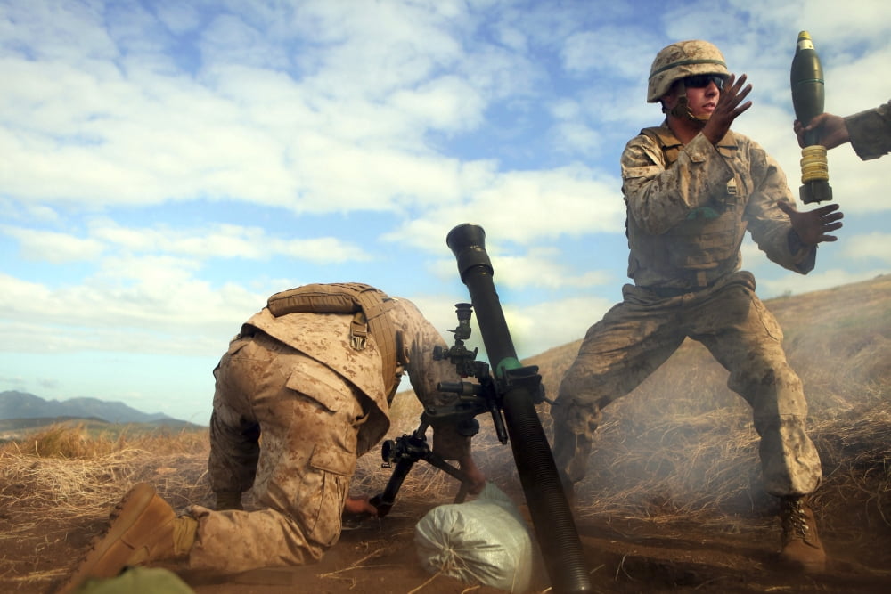 US Marine holds a mortar tube steady as fellow Marine grabs another mortar round Canvas Art - Stocktrek Images (35 x 24)