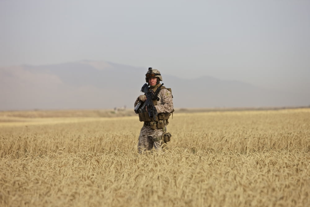 US Marine patrols a wadi near Kunduz Afghanistan Canvas Art - Terry MooreStocktrek Images (18 x 12)