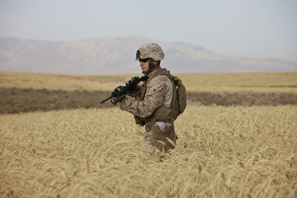 US Marine patrols a wadi near Kunduz Afghanistan Canvas Art - Terry MooreStocktrek Images (18 x 12)