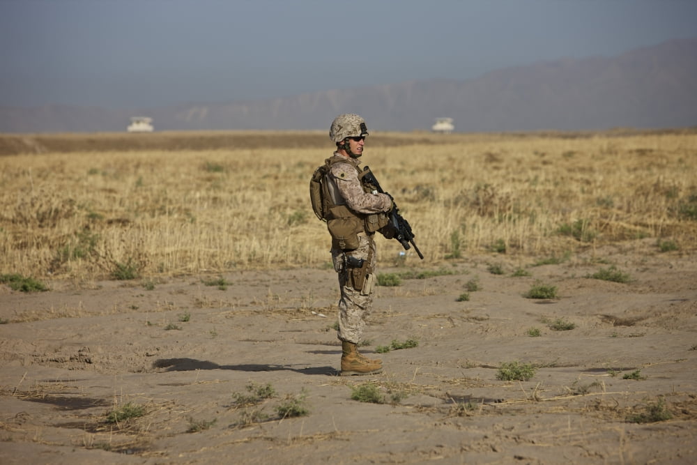 US Marine patrols a wadi near Kunduz Afghanistan Canvas Art - Terry MooreStocktrek Images (18 x 12)