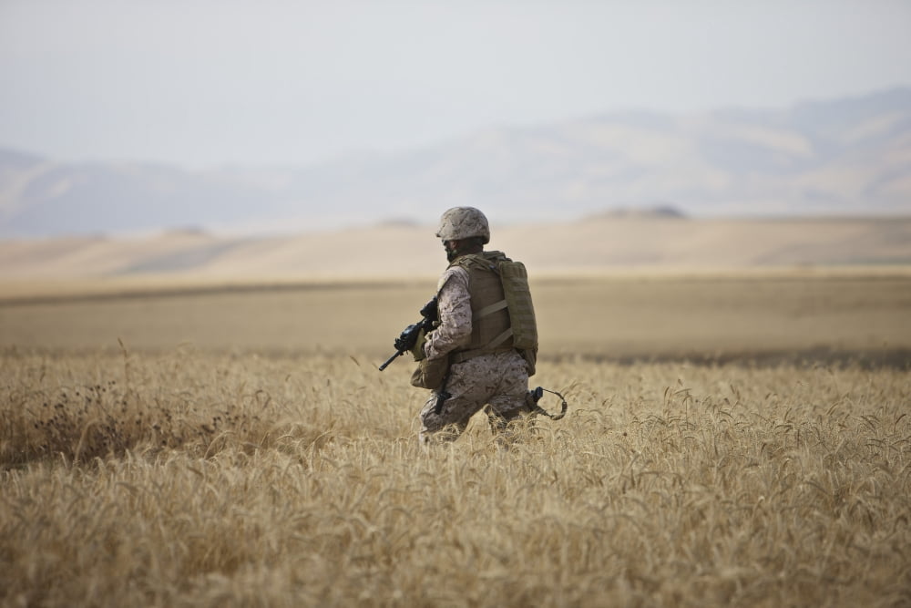 US Marine patrols a wadi near Kunduz Afghanistan Canvas Art - Terry MooreStocktrek Images (35 x 23)