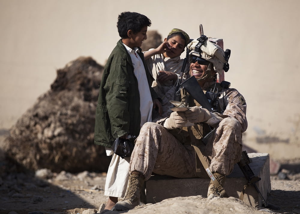 US Marine practices Pashto with Afghan boys in Afghanistan Canvas Art - Stocktrek Images (34 x 24)
