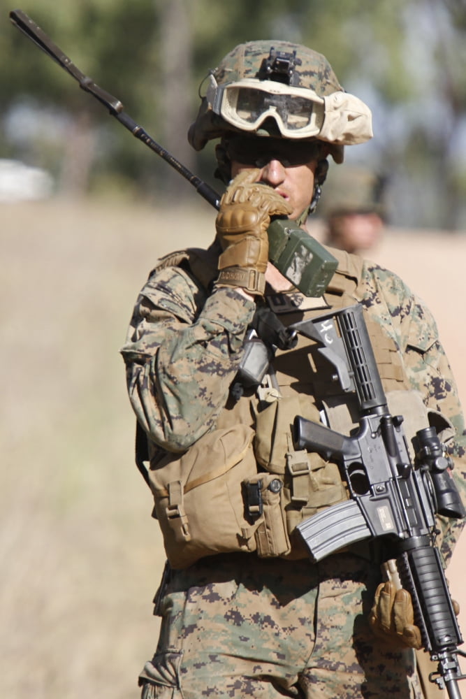 US Marine radios his units movements during a patrol in Australia Canvas Art - Stocktrek Images (23 x 34)