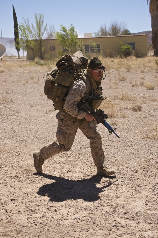 US Marine runs to the UH-60 Black Hawk helicopter Canvas Art - Terry MooreStocktrek Images (12 x 18)