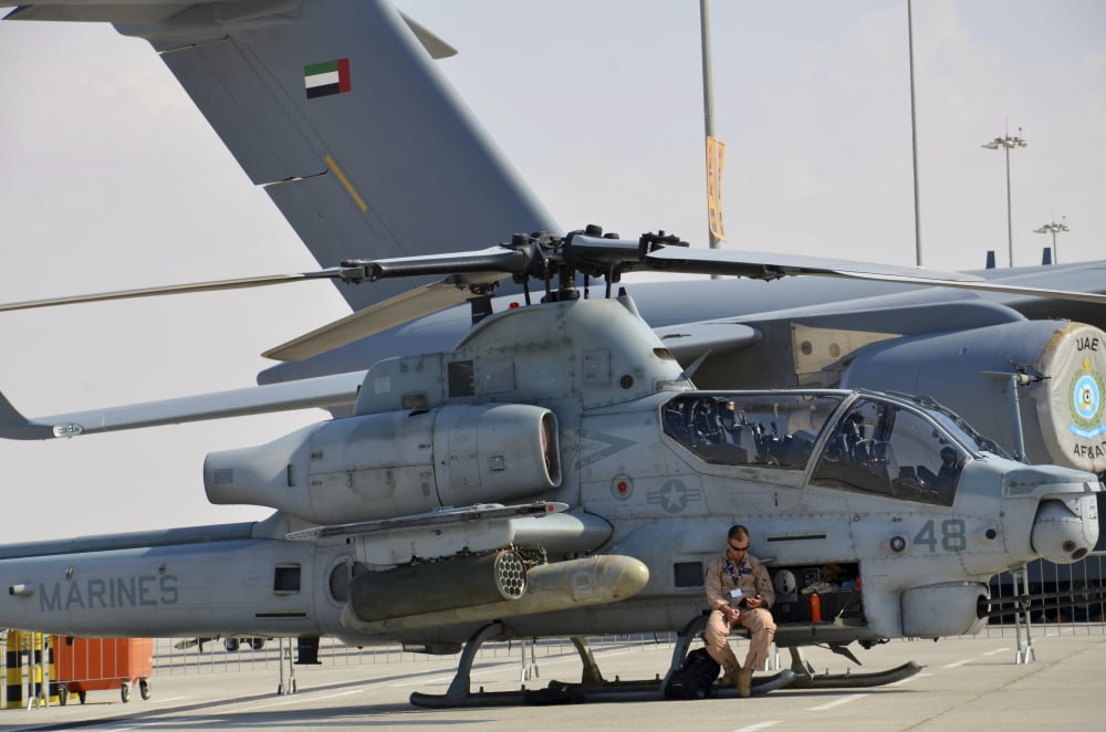 US Marine takes a break sitting on an AH-1Z Cobra attack helicopter Canvas Art - Stocktrek Images (34 x 23)
