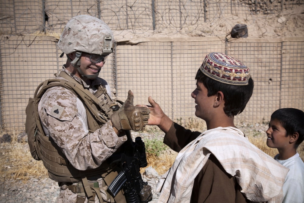 US Marine thumb wrestles with an Afghan boy Canvas Art - Stocktrek Images (35 x 23)