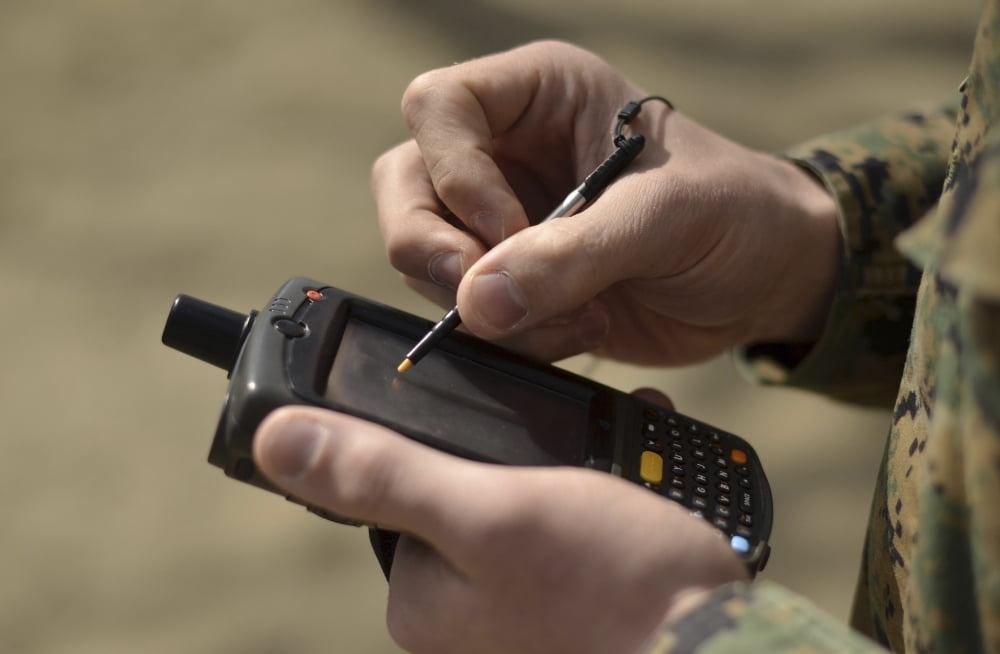 US Marine using GPS capabilities on a handheld device to check his location Canvas Art - Stocktrek Images (35 x 23)