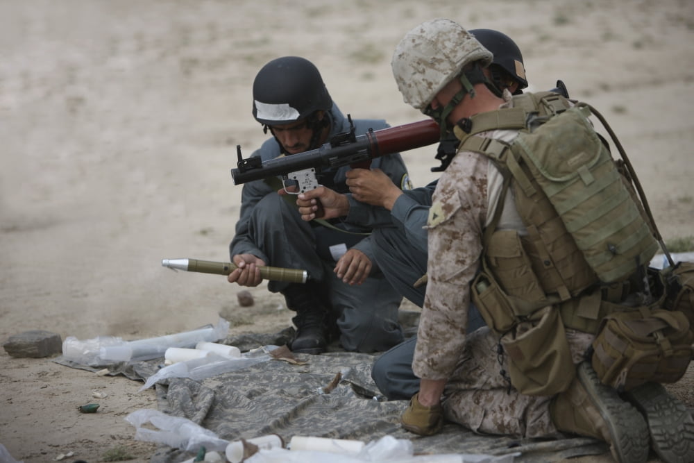 US Marine watches an Afghan Police student prepare a fragmentation rocket Canvas Art - Terry MooreStocktrek Images (35 x 24)