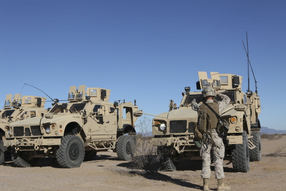 US Marines guides a Mine Resistant Ambush Protected all-terrain vehicle Canvas Art - Stocktrek Images (34 x 23)