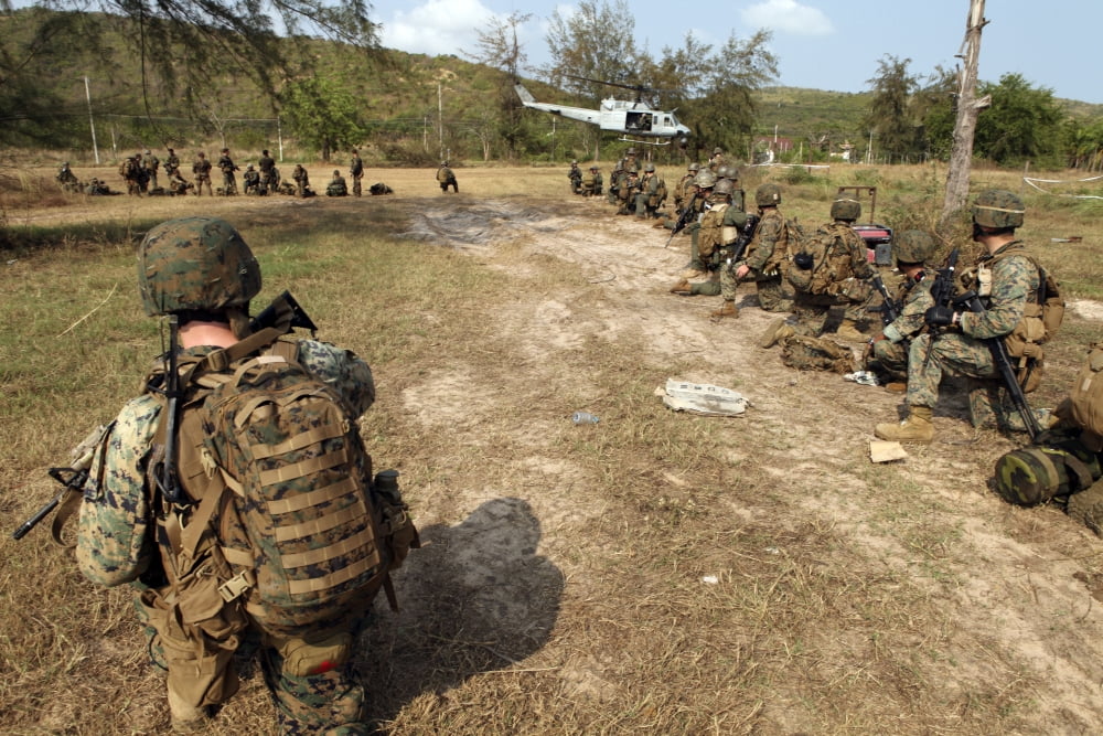 US Marines provide security as a UH-1N Huey helicopter takes off from Thailand Canvas Art - Stocktrek Images (34 x 23)