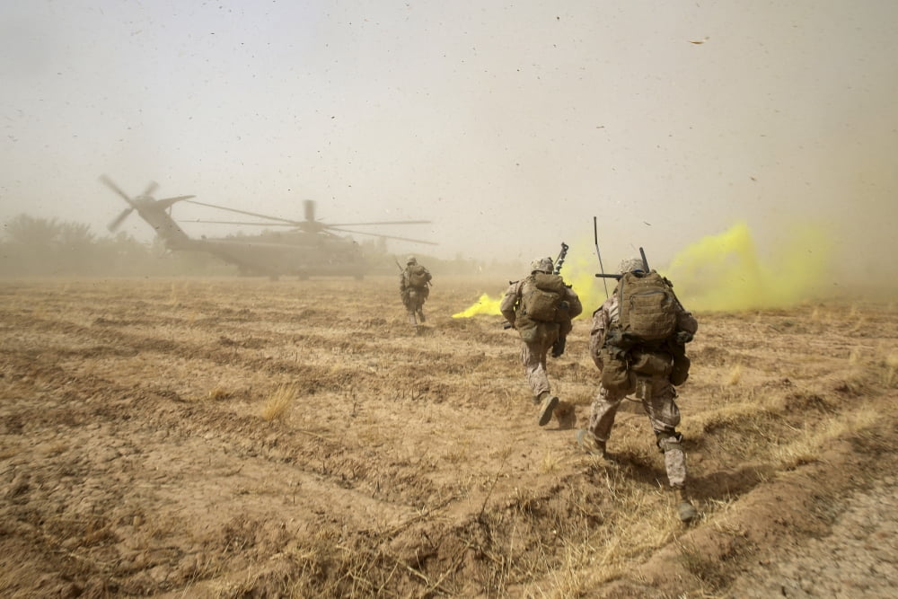 US Marines sprint across a field to load onto a CH-53E Super Stallion Canvas Art - Stocktrek Images (34 x 23)