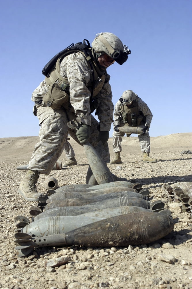 US Marines working with US Navy sailors to stack rockets mortars and bags of propellant in Barwana Iraq Canvas Art - Stocktrek Images (23 x 34)