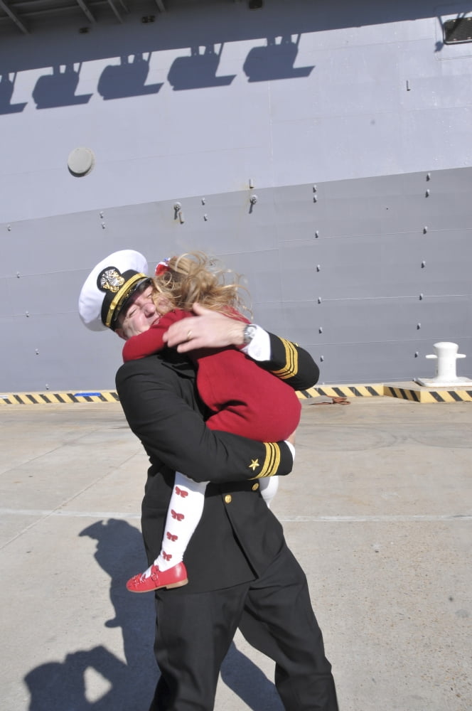 US Navy Commander hugs his daughter during homecoming Canvas Art - Stocktrek Images (23 x 35)