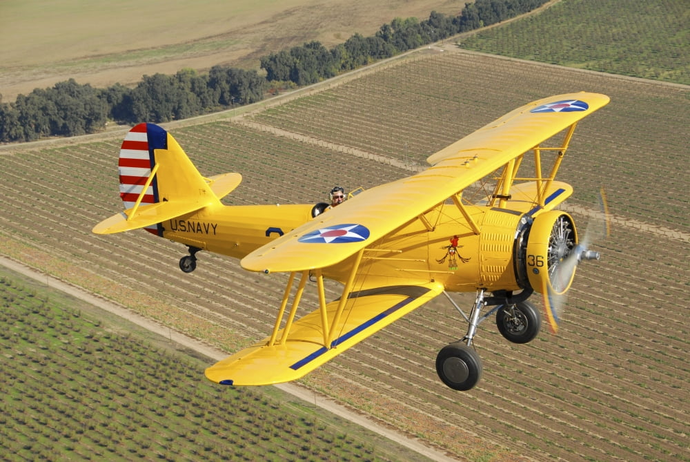 US Navy N3N-3 flying over Chico California Canvas Art - Phil WallickStocktrek Images (17 x 12)