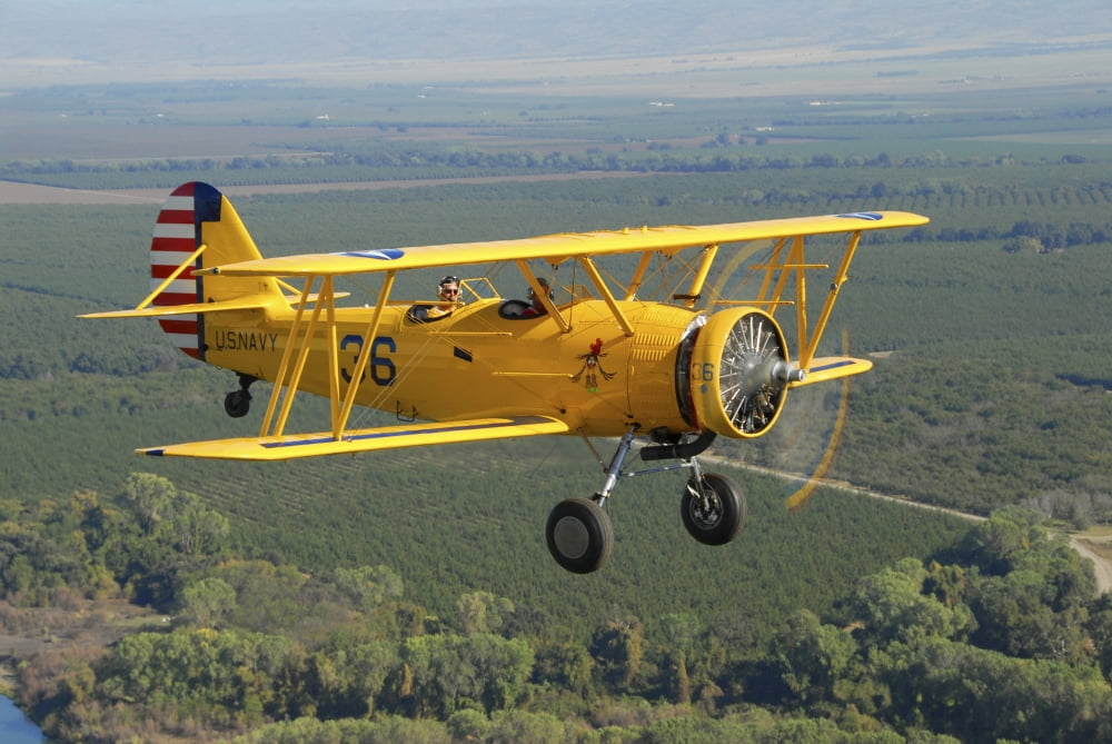 US Navy N3N-3 flying over Chico California Canvas Art - Phil WallickStocktrek Images (17 x 12)