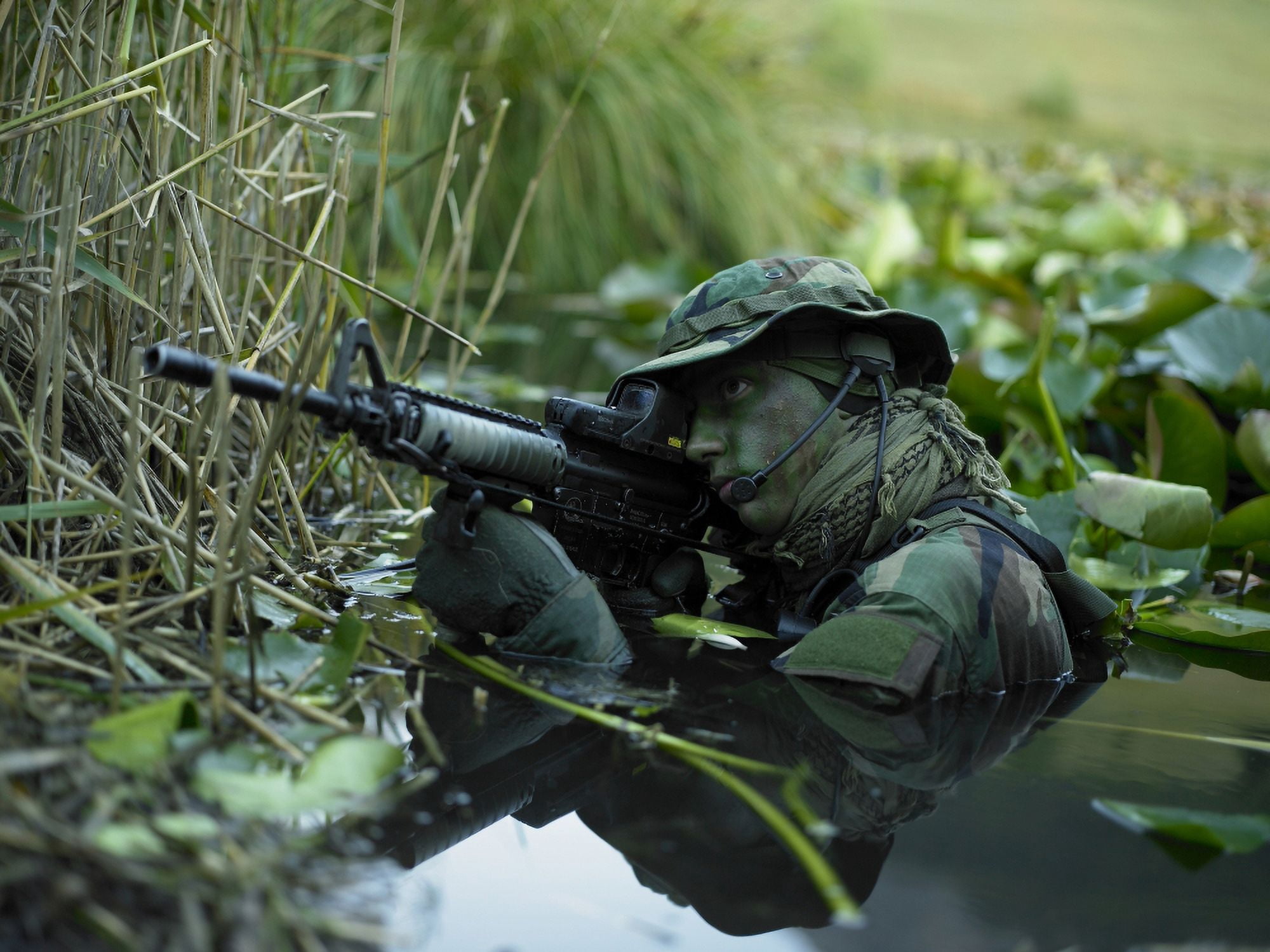 US Navy SEAL crosses through a stream during combat operations Canvas Art - Tom WeberStocktrek Images (33 x 25)