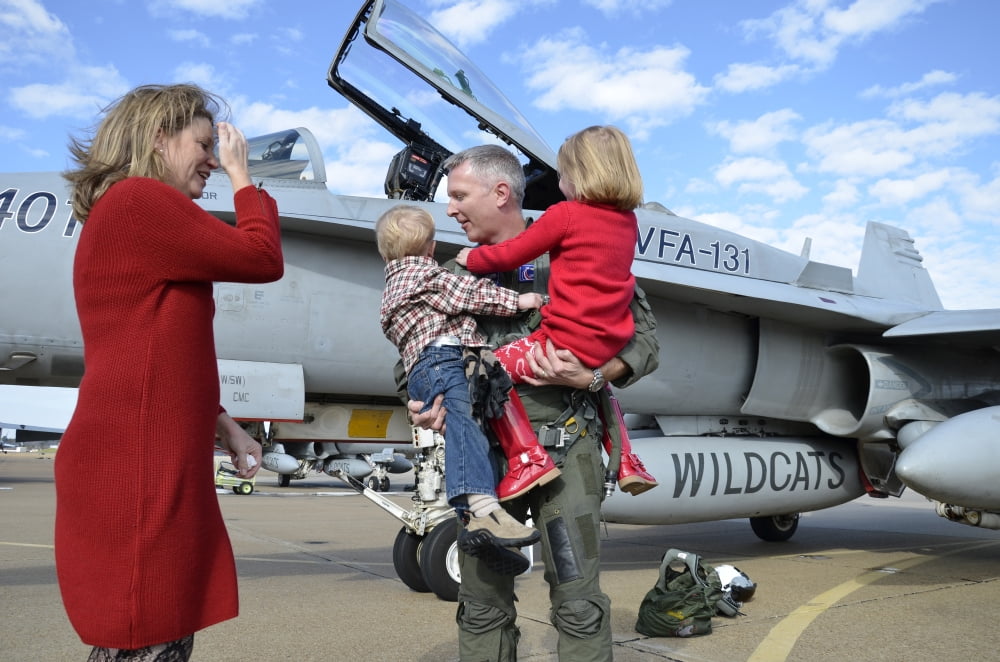 US Navy aviator is reunited with his wife and children during homecoming Canvas Art - Stocktrek Images (35 x 23)