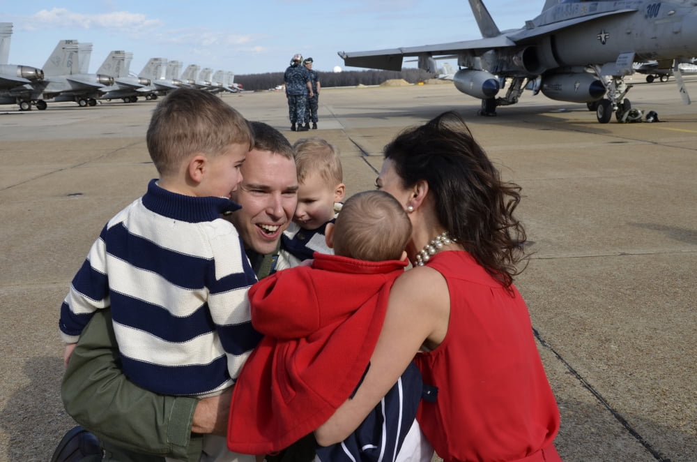 US Navy aviator is reunited with his wife and children during homecoming Canvas Art - Stocktrek Images (35 x 23)
