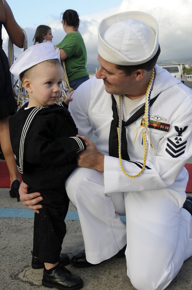 US Navy sailor hugs his son during a homecoming celebration Canvas Art - Stocktrek Images (23 x 35)