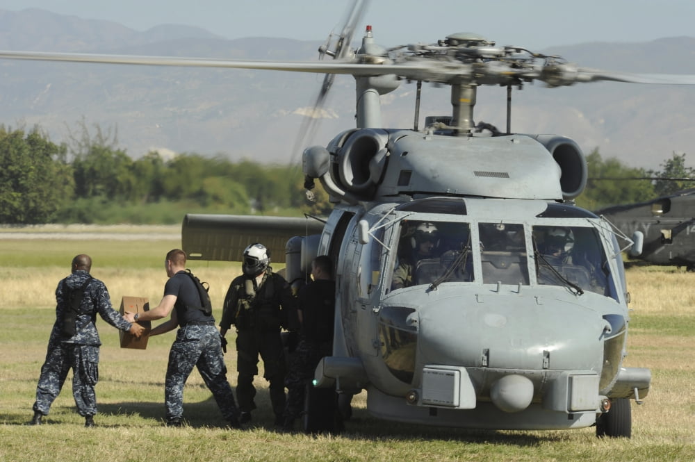 US Navy sailors load humanitarian supplies onto a Navy HH-60 Pave Hawk helicopter Canvas Art - Stocktrek Images (35 x 23)