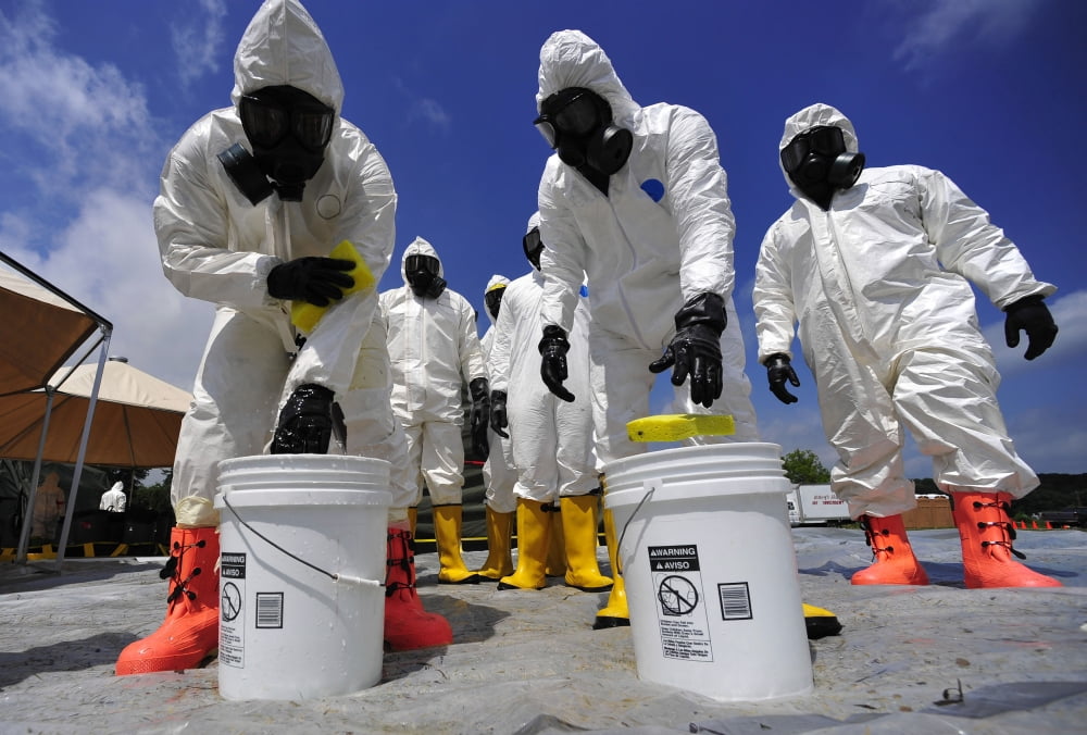 US Soldiers from the 457th Chemical Battalion sponge off their level A protective suits Canvas Art - Stocktrek Images (34 x 23)