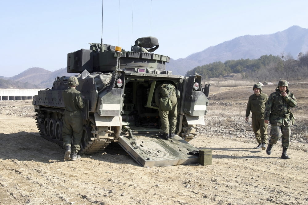 US Soldiers prepare an M2 Bradley Fighting Vehicle Canvas Art - Stocktrek Images (35 x 23)