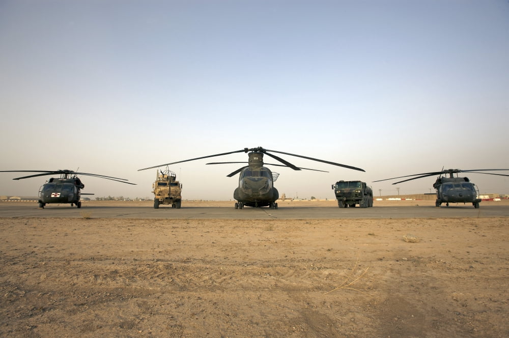 US military vehicles and aircraft lined up on the taxiway at Camp Speicher Iraq Canvas Art - Terry MooreStocktrek Images (35 x 23)