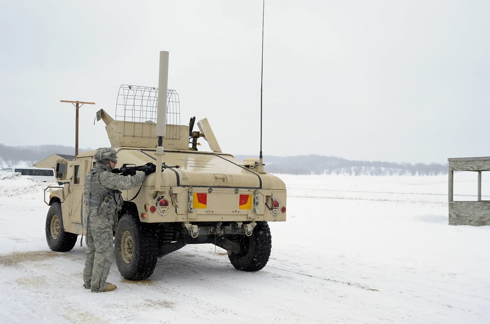 US soldier takes cover behind a humvee during Combat Support Training Exercises Canvas Art - Stocktrek Images (34 x 23)