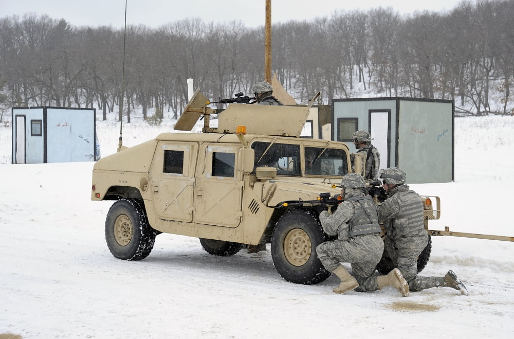 US soldiers take cover behind a humvee during Combat Support Training Exercises Canvas Art - Stocktrek Images (35 x 23)