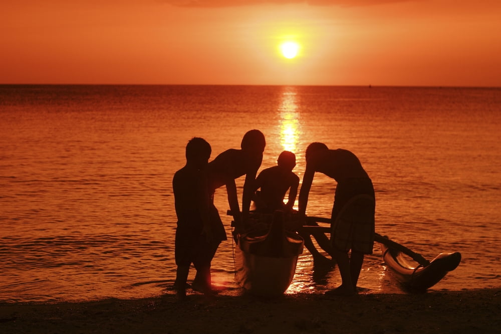USA Hawaii Oahu Boys holding canoe at sunset North Shore Canvas Art - Vince Cavataio Design Pics (17 x 11)