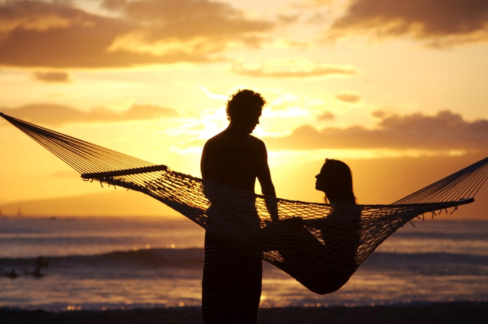 USA Hawaii Oahu Silhouette of woman in hammock and man standing next to her in Kapiolani Park Waikiki Canvas Art - Larry Dale Gordon Design Pics (34 x 22)
