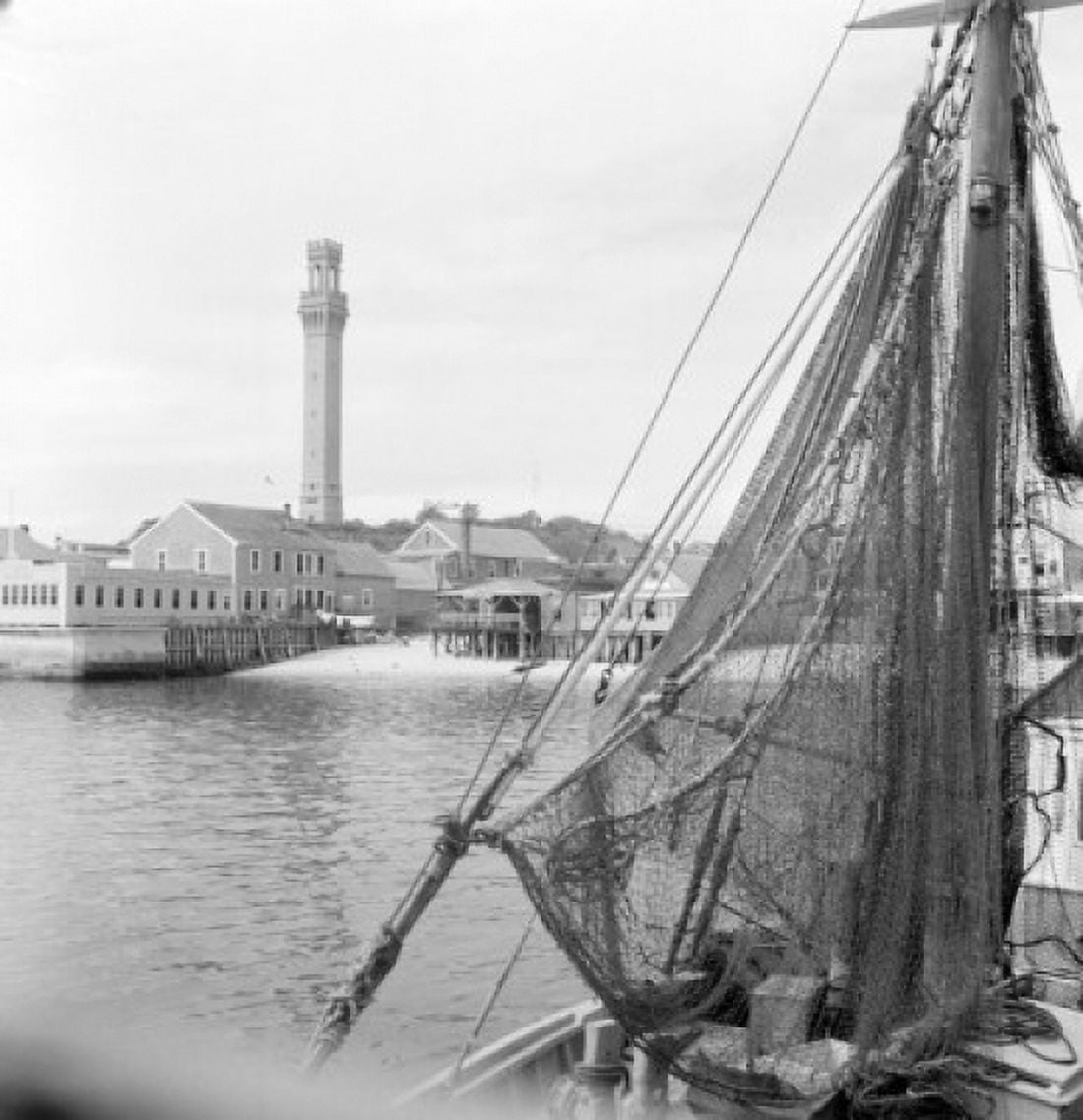 USA Massachusetts Cape Cod Provincetown Fishing net with buildings in the background Canvas Art - (18 x 24)