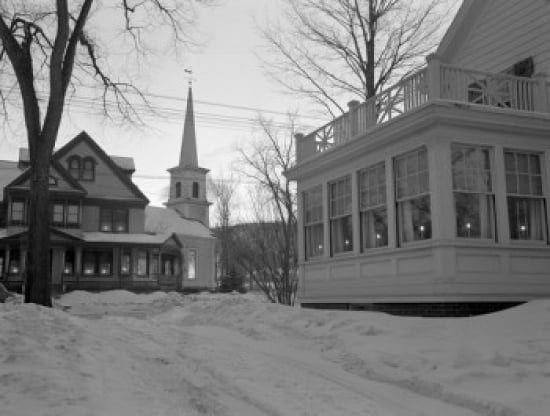 USA New Hampshire Gorham Christmas lights in porch windows church in distance Canvas Art - (18 x 24)