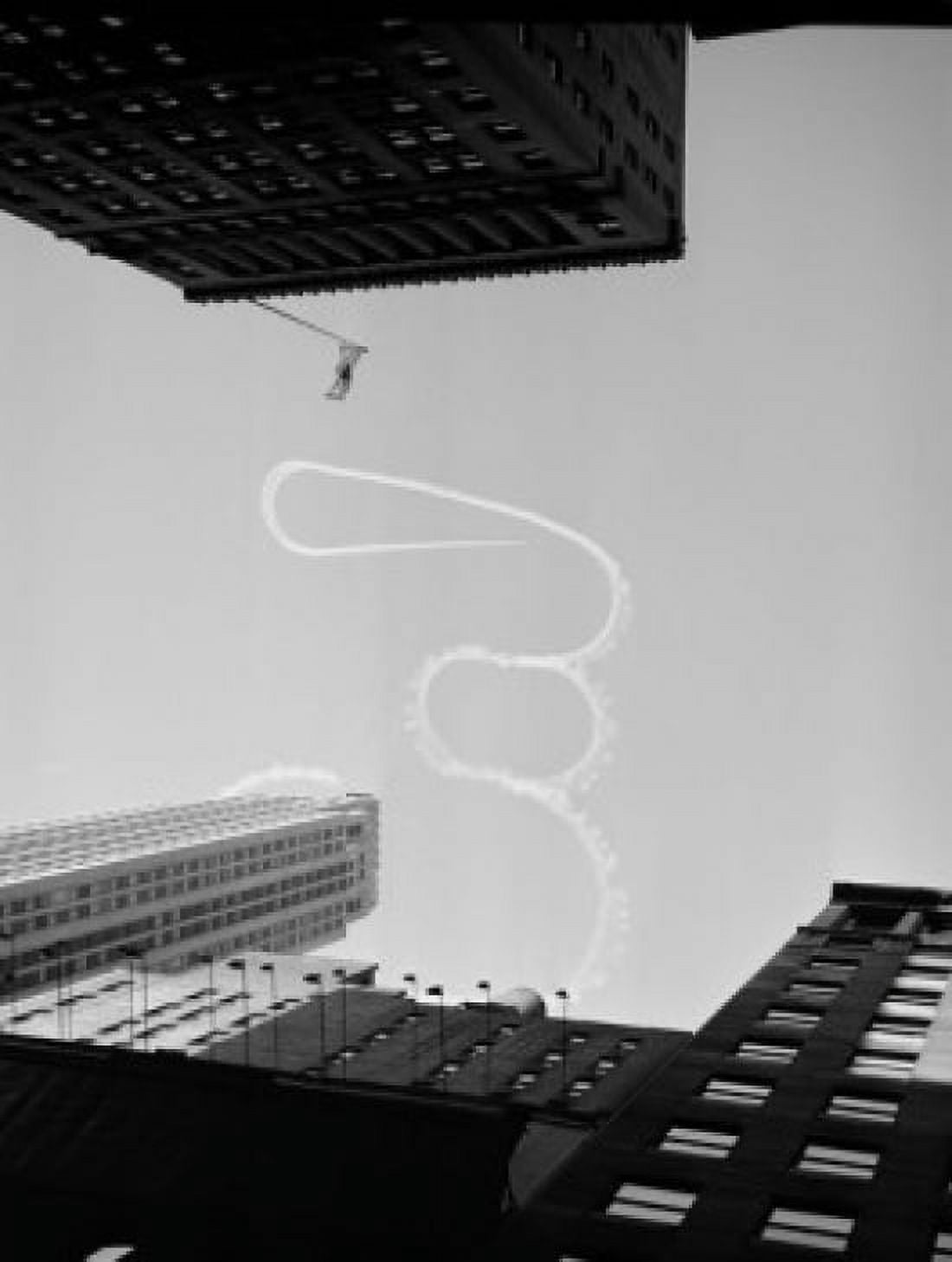 USA New York City Upward view of acrobatic aeroplane vapor trail over skyscrapers Canvas Art - (18 x 24)