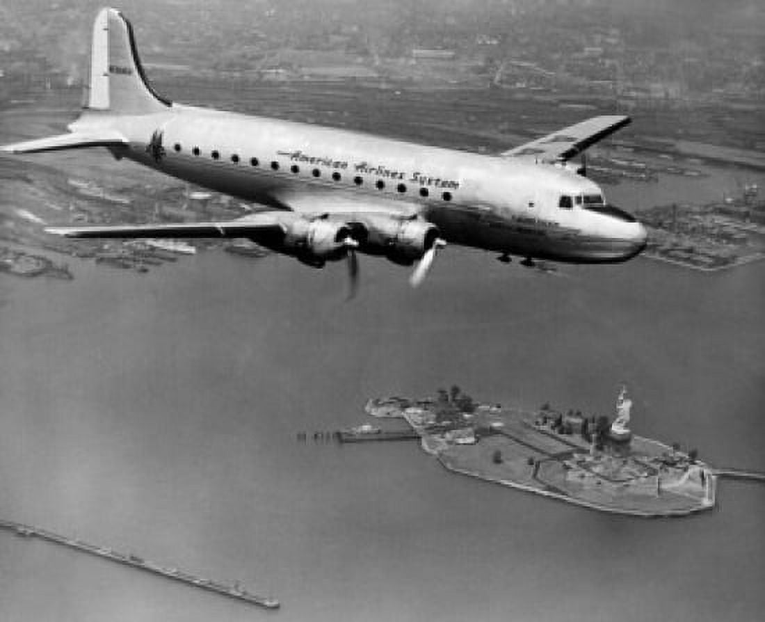 USA New York State New York City New York Harbor American Airlines plane over Statue of Liberty Canvas Art - (18 x 24)