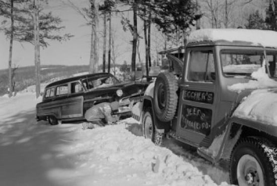 USA Pennsylvania Man connecting tow rope to car in snow Canvas Art - (24 x 36)