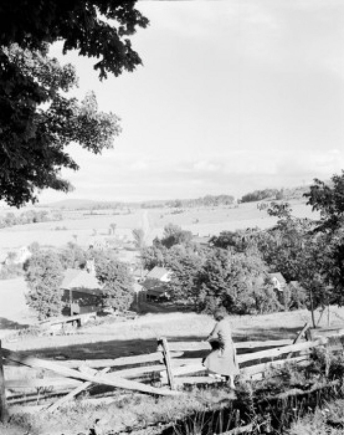USA Vermont West Glover woman leaning against fence looking at village Canvas Art - (18 x 24)