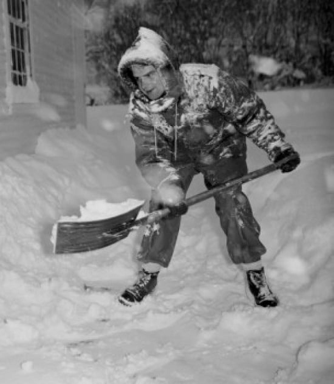 USA Vermont Woodstock man shoveling snow Canvas Art - (24 x 36)
