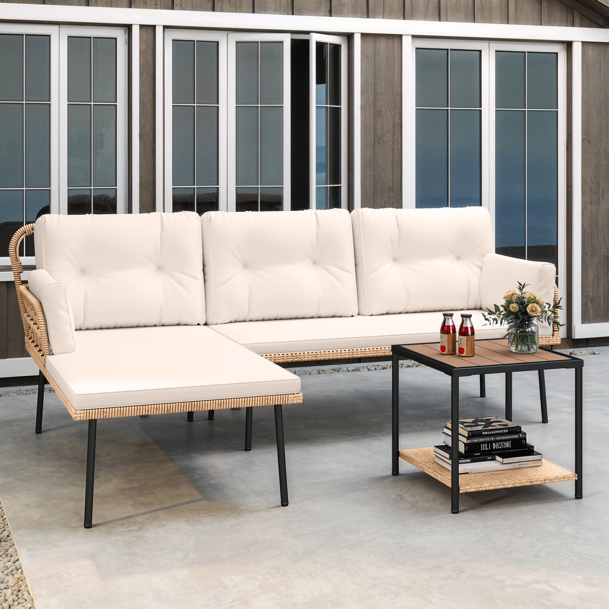 A white outdoor couch and a black and brown table
