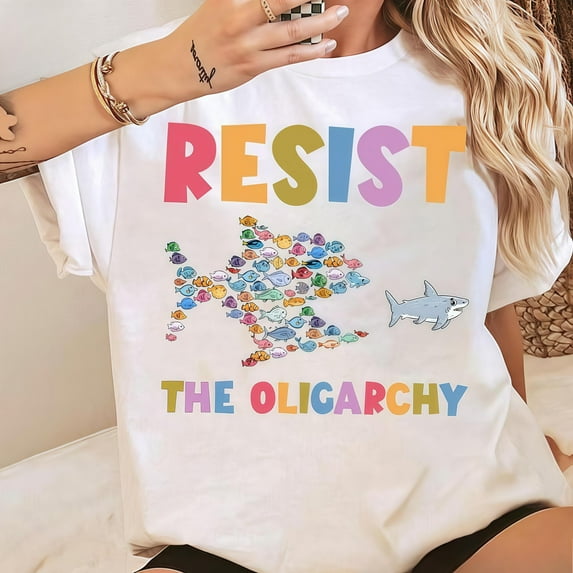 Unisex T-shirts, Stand strong together , featuring a bold shark graphic being chased by a school of colorful fish forming a larger shark shape